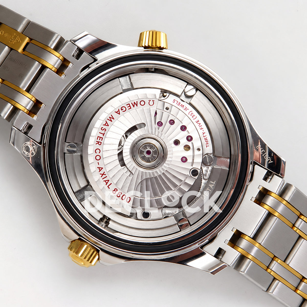 Omega Seamaster Diver 300M ORF Blue Steel Yellow Gold 8800 Free Sprung — open caseback movement view