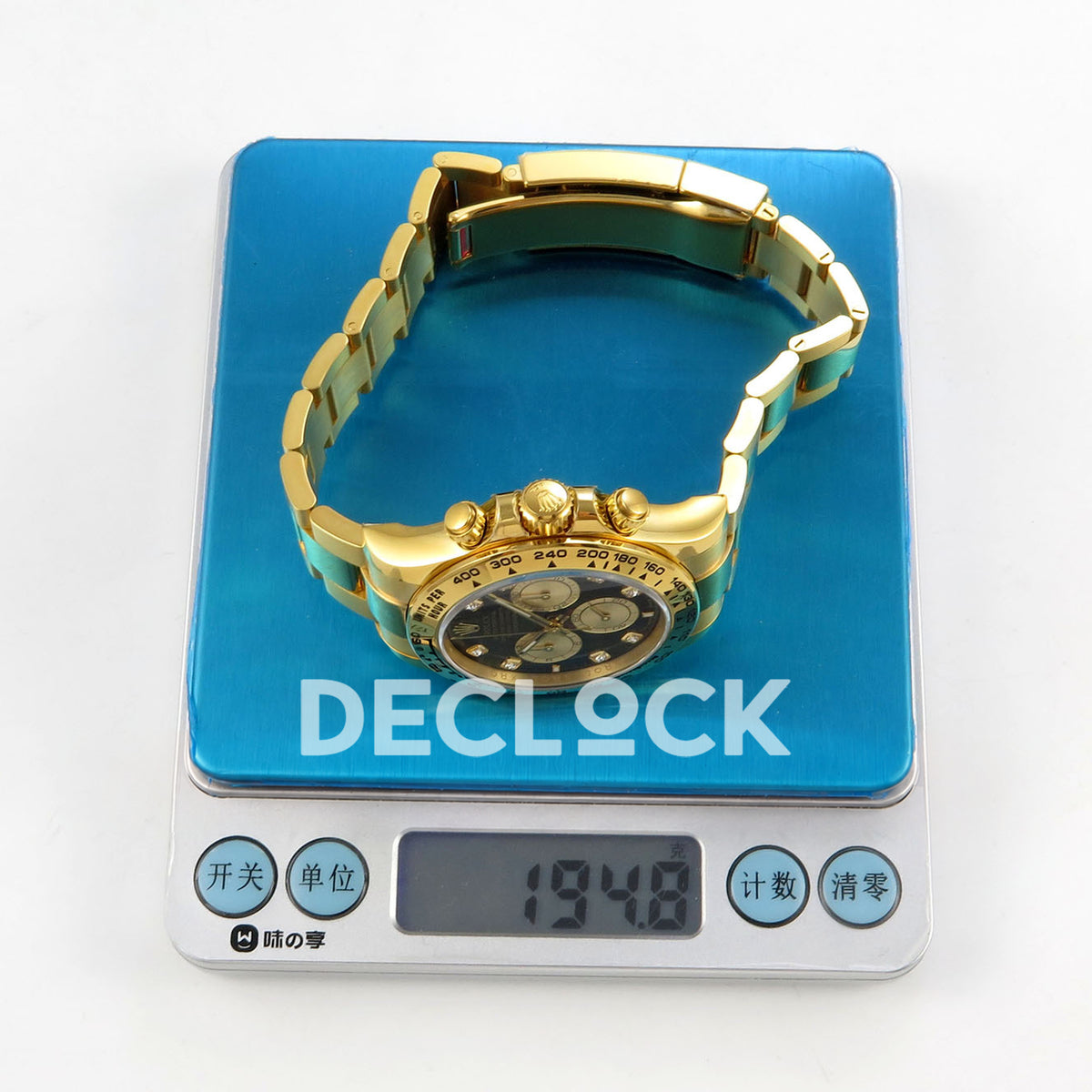 Rolex Daytona 126508 RWF replica - original scale showing 194.8g with watch on blue weighing platform