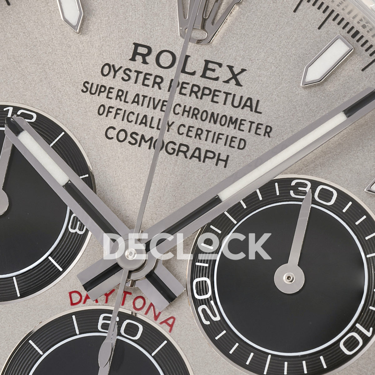Rolex Daytona 126519 ARF replica - macro view of original silver hands, grey textured dial, black counters and red Daytona inscription